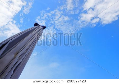 Close Up Umbrella On Blue Sky With Clouds, Sky Clouds Background, Cloudscape Concept. Space For Text