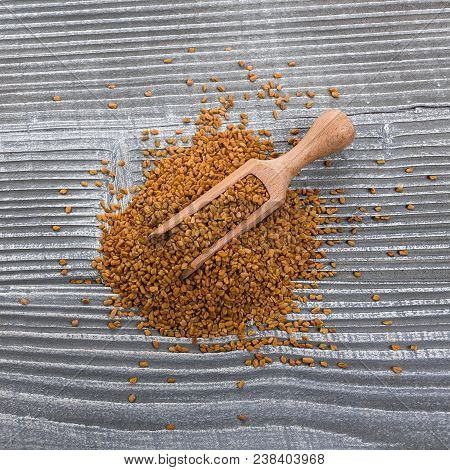 Fragrant Grains Of Fenugreek On A Rustic Background.