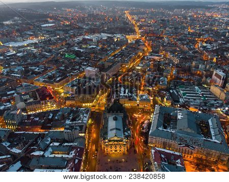 Aerial View Of City In Night Time. Streets In Car Lights.