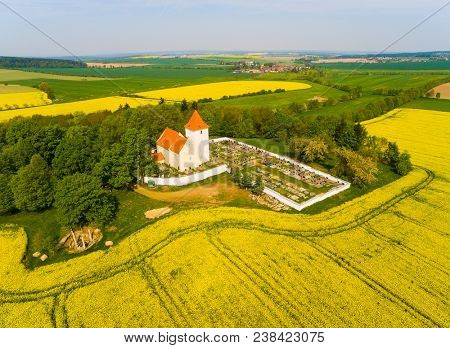 Aerial view to Church St. Vitus with graveyard in Srbice. Romantic place on Czech countryside, Central europe.
