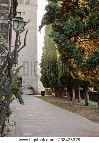 Historical Center Of Sirmione Near Scaligera Castle. Ancient Architecture And Green Trees Of Italy, 