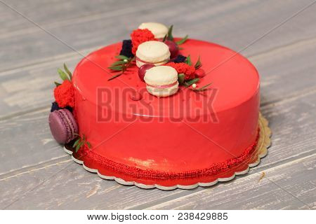 Tasty Red Homemade Cake Decorated By Red Candies And Macarons. Modern Photo