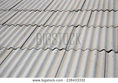 A Fragment Of A Gray Slate Roof Of An Old Sample Made Of Asbestos Material