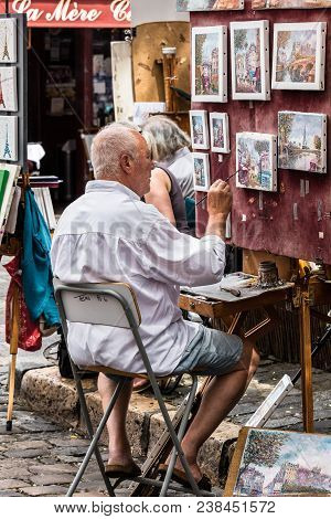 Paris, France - July 06, 2017: The Painter Works At The Open Air Artist Market At The Tertre Square 