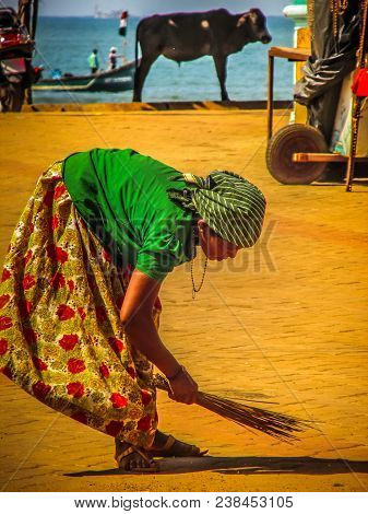 Unknown Woman Cleaning The Street Of Palolem In Goa India October 25-2017 On The Morning