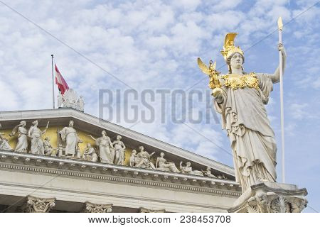 Austrian Parlament With Athena Statue And Flag On Cloudy Sky Used As Background