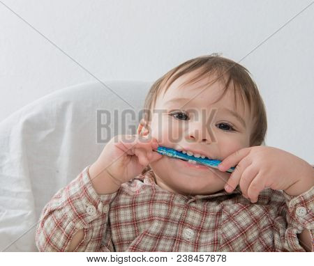 Little baby boy is playing with pen and note book