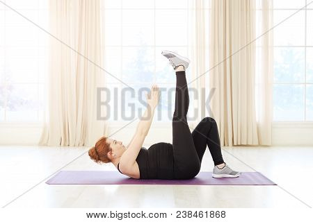 Beautiful Pregnant Woman Practicing Prenatal Yoga Or Pilates Lying On Back Exercising With Upper Bod