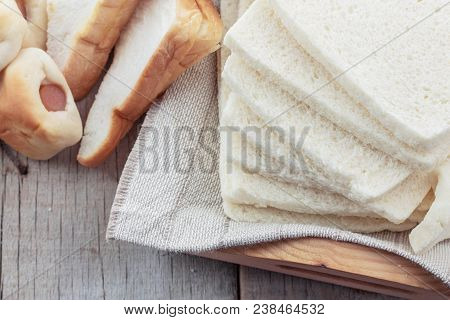 Sliced Bread And Lined On Wooden Floor.