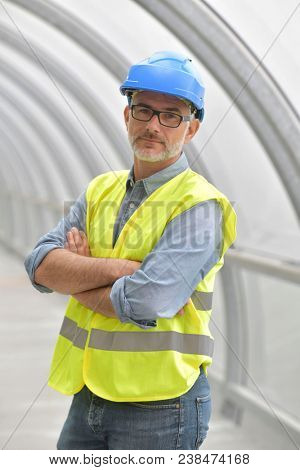 Portrait of industrial engineer with security hat and lifevest