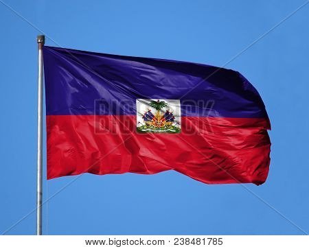 National Flag Of Haiti On A Flagpole In Front Of Blue Sky.