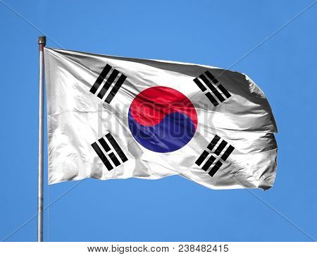National Flag Of South Korea On A Flagpole In Front Of Blue Sky.