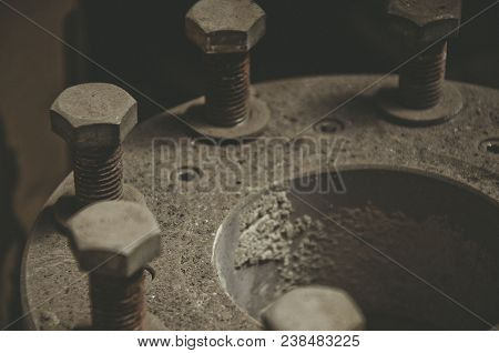 Old Rusty Bolts In The Dust On The Pipe Joint