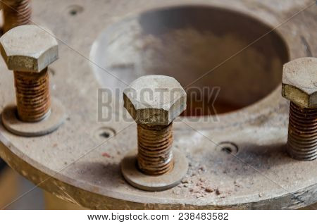 Old Rusty Bolts In The Dust On The Pipe Joint