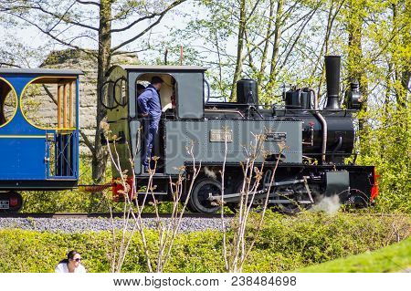 Pairi Daiza,belgium,europe-19/04/2018.departure Of A Steam Locomotive In A Cloud Of Smoke And Steam 