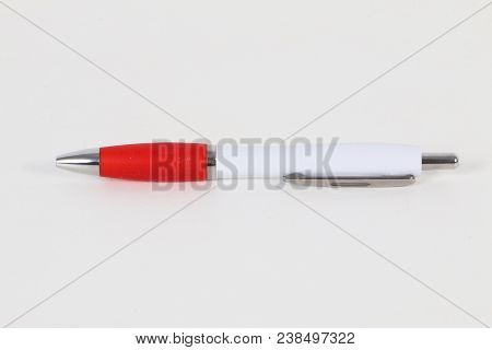 Red And White Ball Pen Is Lyng In The Studio