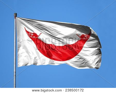 National Flag Of Easter Island Rapa Nui On A Flagpole In Front Of Blue Sky.