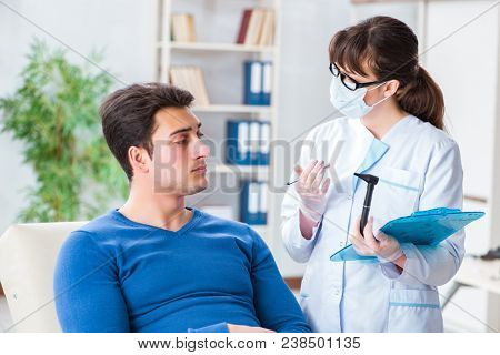 Doctor checking patients ear during medical examination