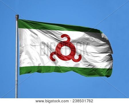 National Flag Of Ingushetia On A Flagpole In Front Of Blue Sky.