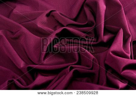 Smooth Red Satin Silk Fabric. Folds, Curl. Satin Background.