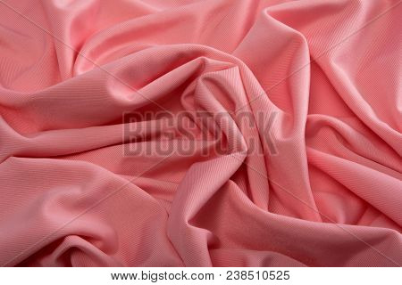 Smooth Pink Satin Silk Fabric. Folds, Curl. Satin Background.