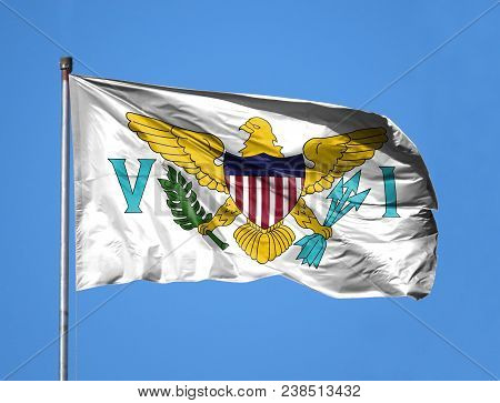 National Flag Of Virgin Islands Of The United States On A Flagpole In Front Of Blue Sky.