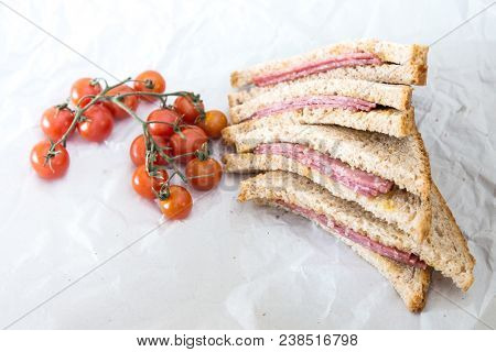 Wholemeal bread sandwich topped with Lyon rosette and butter