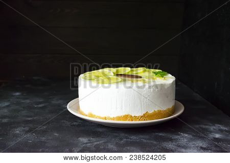 Appetizing Cake With Slices Of Lime On A Dark Background