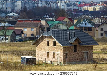 Brand New Spacious Brick Two Story Residential House With Tiling Roof And Windows Openings In Suburb