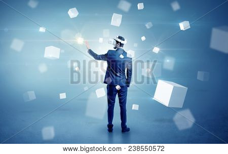 Handsome businessman with vr goggle and falling white cubes around