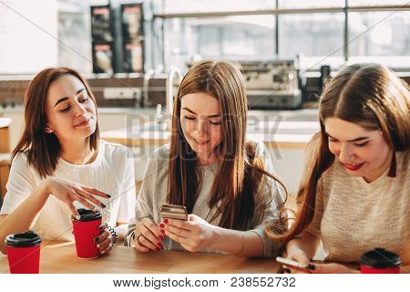 Group Of Women Engrossed In Typing On Smart Phone While Their Friend Trying To Speak To Them