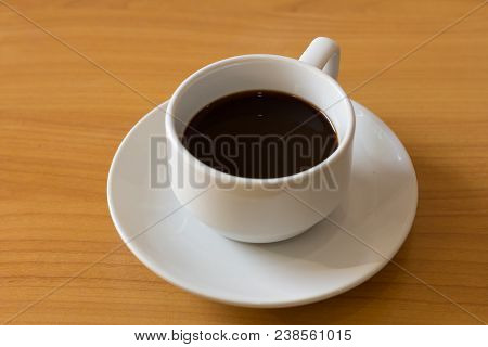 Black Coffee Cup On Wooden Table In The Coffee Shop