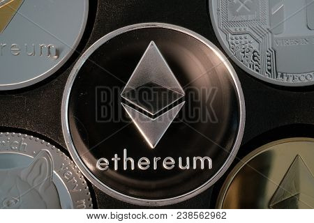 Ethereum Cryptocurrency Real Silver Coin In Middle Of Other Crypto Closeup