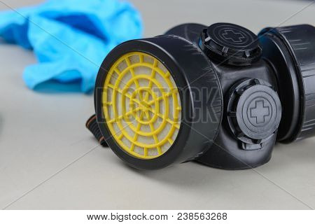Respirator, Goggles And Blue Medical Gloves On Table