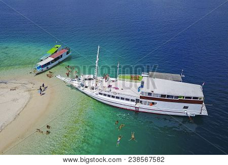 Beautiful Aerial View Of Beaches And Tourist Boat Sailing In Flores Island, Indonesia.