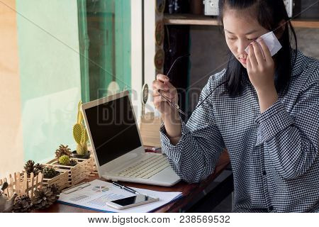 Businesswoman Tired From Work And Eye Pain. In The Coffee Shop