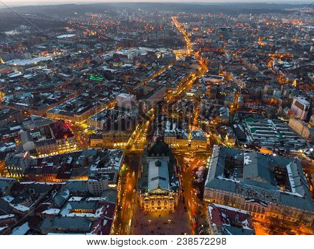 Aerial View Of City In Night Time. Streets In Car Lights.