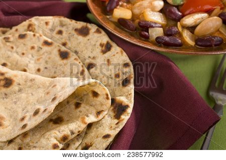 Indian Chapatis Or Rotis With Vegetarian Curry.