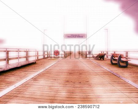 Abstract Effect.  Old Wood Beach Bridge In Goehren With Nobody. Autumnal Misty Weather With Cloudy S