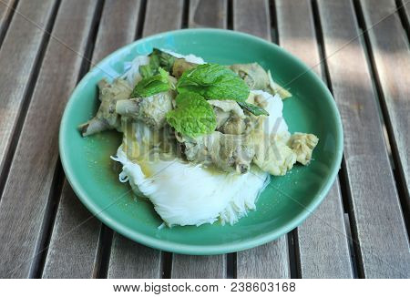 Thai Noodles With Chicken Curry (kanom Jeen) In A Green Dish On A Food Table.