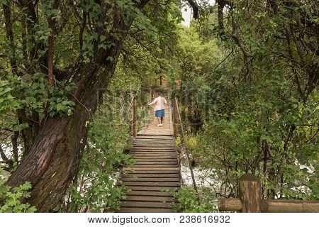 Royal Natal National Park, South Africa - March 17, 2018: An Unidentified Tourist On A Pedestrian Br