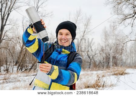 Young Gyu With Thermos On Snow Forest Background.