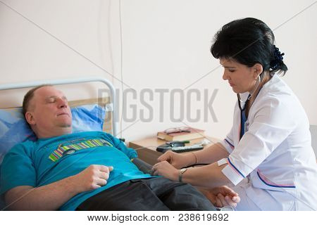 Belarus, Gomel, 24 April 2018. The Gomel Central Hospital.the Doctor Measures The Pressure On The Pa