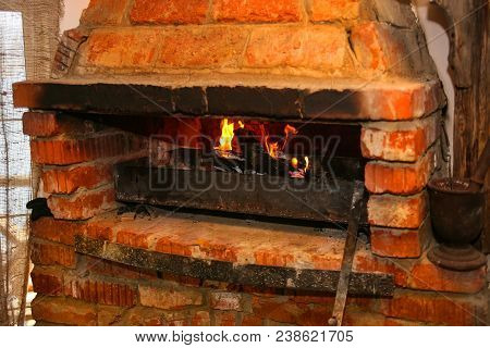 Burning Firewood In Old Brick Furnace Photo