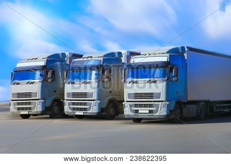 Three Trucks Go On Wide Highway Group