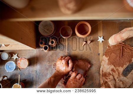 Male Potter Molding A Clay In Pottery Workshop, Close-up, Selective Focus.