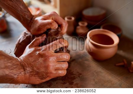 Hands Of Male Potter Molding A Clay In Pottery Workshop, Close-up, Selective Focus. Creative Work Pr