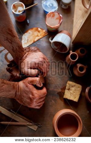 Hands Of Male Potter Molding A Clay In Pottery Workshop, Close-up, Selective Focus. Creative Work Pr