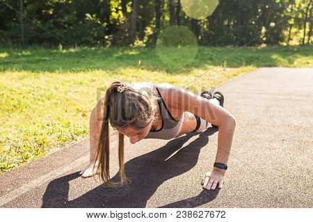 Fitness Woman Doing Push-ups During Outdoor Cross Training Workout. Beautiful Young And Fit Fitness 
