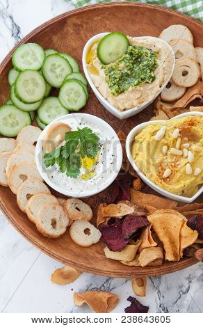 Variety Of Hummus And Cream Cheese And Vegetable Chips For Dipping